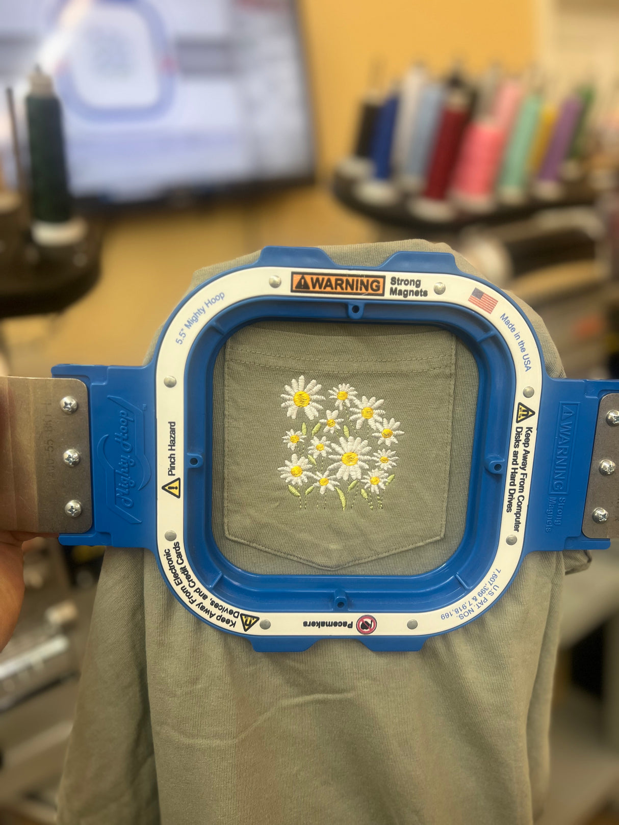 Pocket of Daisy Embroidered on a Port & Co Soft Style T-shirt