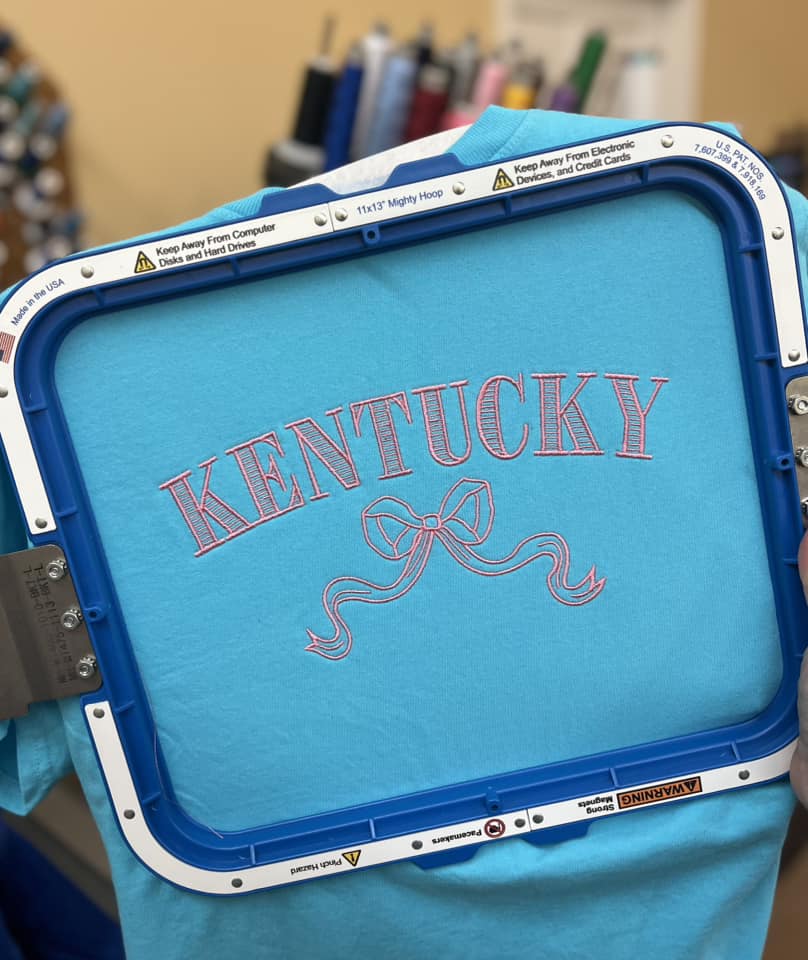 Kentucky Bow Embroidered on a Port & Co Soft Style T-shirt